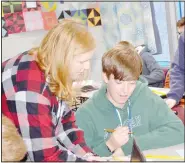  ?? (NWA Democrat-Gazette/Marc Hayot) ?? Dr. Elizabeth Wieneke helps Eli Shinkle with the sketch of his “nonprofit” for a project for Wieneke’s Honors History class on March 1. Wieneke is one of the teachers in the Siloam Springs School District who has mastered the “art of teaching.”