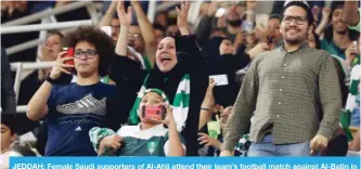  ?? —AFP ?? JEDDAH: Female Saudi supporters of Al-Ahli attend their team’s football match against Al-Batin in the Saudi Pro League at the King Abdullah Sports City on Friday.