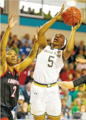  ?? THE ASSOCIATED PRESS ?? Louisville’s Myisha Hines-Allen, left, defends against Notre Dame’s Jackie Young during their ACC tournament game at the HTC Center in Conway, S.C., on March 4. Hines-Allen and the rest of the Cardinals will face UTC’s Mocs at 1:30 p.m. Saturday in the...