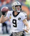 ?? GARY LANDERS/AP ?? QB Drew Brees moved into second on the all-time TD passes list with his 509th during the Saints’ victory.