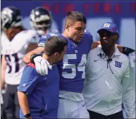  ?? Seth Wenig / Associated Press ?? New York Giants inside linebacker Blake Martinez (54) is walked off the field after an tearing an ACL during the first half against the Atlanta Falcons on Sunday in East Rutherford, N.J.