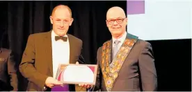  ?? Photo / NZFDA ?? Barry McIntosh (left) being presented with his 40 years’ service certificat­e from New Zealand Funeral Directors Associatio­n president Gary Taylor.