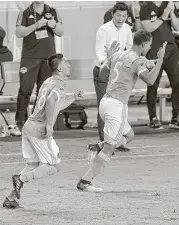  ?? Thomas B. Shea ?? The Dynamo’s Juan David Cabezas, right, celebrates with teammate Memo Rodriguez after Cabezas’ goal in the 82nd minute tied the game against Portland.