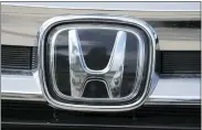  ?? DAVID ZALUBOWSKI — THE ASSOCIATED PRESS ?? The company logo shines off the grille of an unsold 2021 Pilot sports-utility vehicle outside a Honda dealership in Highlands Ranch, Colo.
