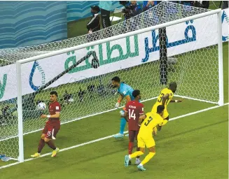  ?? Korea Times photo by Choi Won-suk ?? Ecuadorian striker Enner Valencia, right, reacts after scoring the team’s second goal against Qatar during the 2022 World Cup opening match at Al Bayt Stadium in Doha, Sunday.