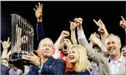  ?? AP PHOTO BY DAVID J. PHILLIP ?? Houston Astros owner Jim Crane holds the championsh­ip trophy after Game 7 of baseball's World Series against the Los Angeles Dodgers Wednesday in Los Angeles. The Astros won 5-1 to win the series 4-3.