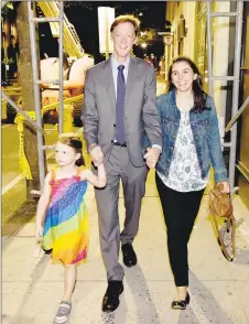  ?? Peter Hvizdak / Hearst Connecticu­t Media ?? Justin Elicker, with his wife, Natalie, and daughter, Molly, 4, walks to the party celebratin­g his victory in the Democratic mayoral primary at the Trinity Bar & Grill in New Haven on Tuesday.