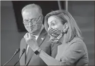  ?? AP-J. Scott Applewhite ?? Speaker of the House Nancy Pelosi, D-Calif., and Senate Minority Leader Chuck Schumer, D-N.Y., left, meet with reporters on Capitol Hill in Washington, on Thursday.