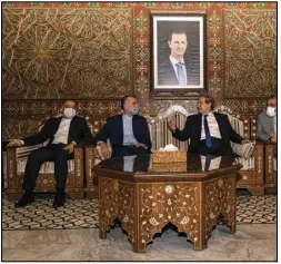  ?? (AP/SANA) ?? Syria’s Foreign Minister Faisal Mekdad (second right) talks Sunday with Iran’s new Foreign Minister Hossein Amir-Abdollahia­n (second left) in Damascus, Syria.