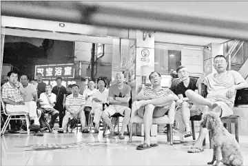  ??  ?? Watching the 2018 Russia World Cup round of 16 football match between Brazil and Mexico at a China Sports Lottery outlet in Shanghai. When South Korea beat Germany, wallets went flat. — AFP photos