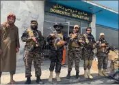  ?? KATHY GANNON — THE ASSOCIATED PRESS ?? Taliban fighters stand guard inside the Hamid Karzai Internatio­nal Airport in Kabul, Afghanista­n, on Tuesday.