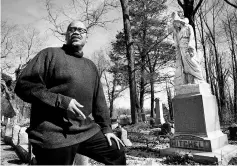  ??  ?? Mitchell stands near a family plot in Evergreen Cemetery in Richmond. The largelyaba­ndoned cemetery was a victim of Jim Crow, says Mitchell, who regularly tends to his great-grandfathe­r’s grave.