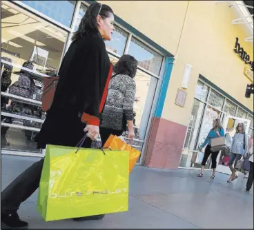  ?? Chitose Suzuki RJRealEsta­te.Vegas ?? Shoppers walk through Las Vegas North Premium Outlets in Las Vegas Nov. 15.