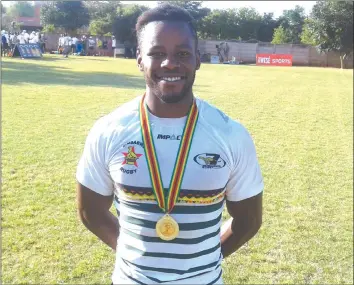  ??  ?? SMILE BEFORE THE STORM . . . Zimbabwe captain Hilton Mudariki smiles while displaying his winners’ medal in Victoria Falls on Sunday