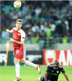  ??  ?? Arsenal’s Nacho Monreal (left) in action with Qarabag’s Innocent Emeghara during the UEFA Europa League group E match in Baku. — Reuters photo