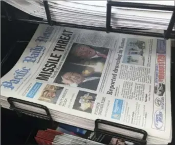  ?? TASSANEE VEJPONGSA — THE ASSOCIATED PRESS ?? A copy of the local newspaper is for sale in Hagatna, Guam on Thursday. The small U.S. territory of Guam has become a focal point after North Korea’s army threatened to use ballistic missiles to create an “enveloping fire” around the island. The...