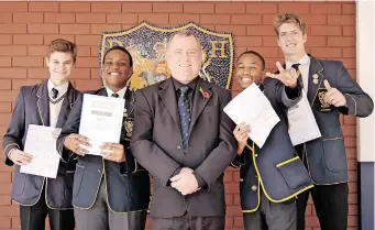  ?? ?? DURBAN High School matric pupils, from left, Connor Dewing, Aphelele Madonda, Omhle Zuma and Michael Russel with physics teacher Rob Smythe after the physics paper 2 exam. | TUMI PAKKIES/AFRICAN News Agency (ANA)