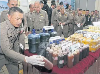  ?? TAWATCHAI KEMGUMNERD ?? A haul of drugs and their precursors are displayed at a news conference held at the Narcotics Suppressio­n Bureau yesterday. Officers announced the recent arrest of 21 people allegedly linked with seven drug cases.