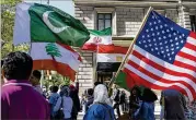  ?? CRAIG RUTTLE / ASSOCIATED PRESS ?? Marchers in September carry the national flags of Pakistan, Lebanon, Iran, Egypt and the United States during the Muslim Day Parade on Madison Avenue in New York.