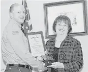  ?? George Wong / For the Chronicle ?? Harris County Emergency Services District 48 Fire Department Lt. Simon VanDyk received the first Chief Gary Tilton Firefighte­r of the Year Award from JoAnn Tilton.