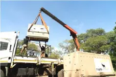  ??  ?? Rangers watch as the truck carrying the lions leaves Majete Wildlife Reserve.