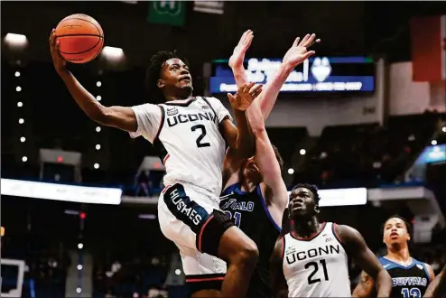  ?? Jessica Hill / Associated Press ?? UConn’s Tristen Newton goes up for a basket as Buffalo’s Isaac Jack defends on Tuesday at the XL Center in Hartford.