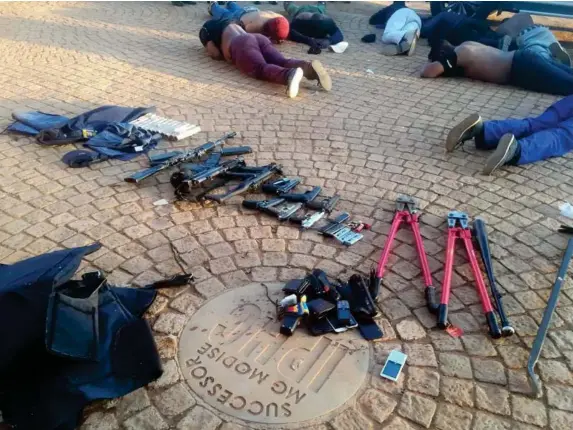  ?? (AP) ?? Suspects and confiscate­d weapons at a South African church yesterday