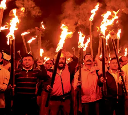  ??  ?? BURNING RAGE A torchlight protest against the Citizenshi­p Amendment Bill in Guwahati, December 9