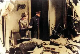  ?? ?? Believed to be the last photo of Hitler alive, one day before his suicide, he emerges from the bunker to survey the ruined Reich Chanceller­y