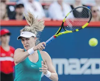  ?? MINAS PANAGIOTAK­IS/GETTY IMAGES ?? Westmount’s Eugenie Bouchard returns the ball against Dominika Cibulkova of Slovakia during Day 3 of the Rogers Cup at Uniprix Stadium Wednesday.