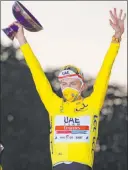  ?? The Associated Press ?? Christophe Ena
Tadej Pogacar celebrates on the podium Sunday after winning the Tour de France. The 21-year-old Slovenian is the event’s youngest winner in 116 years.