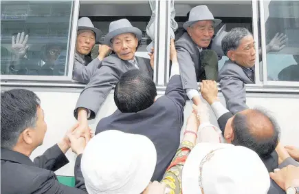  ?? Photo / AP ?? Emotions have run high at the end of past reunions, with relatives reaching out for each other as they part.