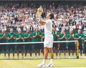 ?? Picture: GETTY IMAGES ?? Roger Federer lifts his 19th grand slam crown and eighth at Wimbledon.