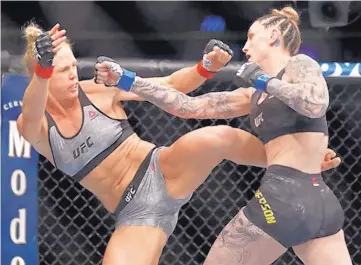  ?? JIM YOUNG/ASSOCIATED PRESS ?? Holly Holm, left, seen here fighting against Megan Anderson in June of 2018, is scheduled to fight against Raquel Pennington in Las Vegas, Nev. on Jan. 18.