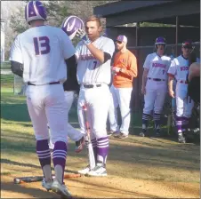  ?? STAFF PHOTO BY ANDY STATES ?? McDonough’s David Larson is greeted at the plate by Peyton Myers following his solo home run in the fourth inning of the Rams’ game with the visiting Huntingtow­n on Tuesday afternoon. McDonough won the game 2-1 in nine innings.