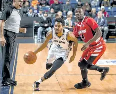  ?? COLIN DEWAR/ SPECIAL TO POSTMEDIA ?? Niagara's Jaylon Tate, with the ball, drives up the court while being defended by Windsor's Michael Acheampong in National Basketball League of Canada action Sunday afternoon at Meridian Centre in St. Catharines.