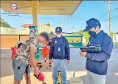  ?? CCF ?? CCF officials inspect a fuel pump at a petrol depot in Battambang province on December 2.