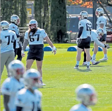  ?? STUART CAHILL / BOSTON HERALD ?? The team stretches out as the Patriots practice for the first time in several days on Saturday.