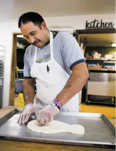  ??  ?? Bernardino Jaquez prepares dough for skull-shaped Día de los Muertos pan dulce Tuesday at Panaderia Zaragoza.