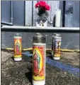  ?? STEFANIE DAZIO — APE ?? In this file photo, candles, a flower and a photograph of Azucena Lepe are displayed at the Shell gas station where Lepe was killed by a man who went on a shooting spree in the North Hollywood district of Los Angeles.