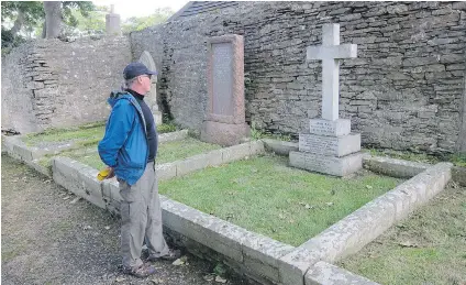  ?? MIKE FUHRMANN/THE CANADIAN PRESS ?? Jay Morrison of Wakefield, Que., stands next to the grave of 19th-century Arctic explorer John Rae in the cemetery next to St. Magnus Cathedral in Kirkwall, capital of Orkney. Rae charted more than 2,000 kilometres of Canada’s northern coastline.