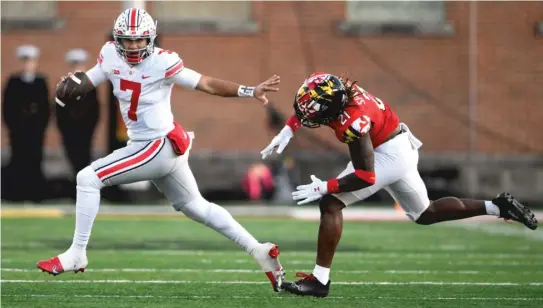  ?? NICK WASS/AP ?? Ohio State quarterbac­k C.J. Stroud scrambles past Maryland linebacker Gereme Spraggins during the first half Saturday in College Park, Maryland.