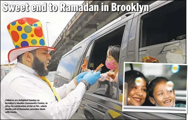  ??  ?? Children are delighted Sunday as Brooklyn’s Muslim Community Center, in drive-by celebratio­n of Eid al-Fitr, which marks end of Ramadan, provides them with treats.