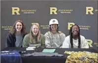  ?? / Kevin Myrick ?? Senior players joined Emily Loveless for a photo during her signing day.