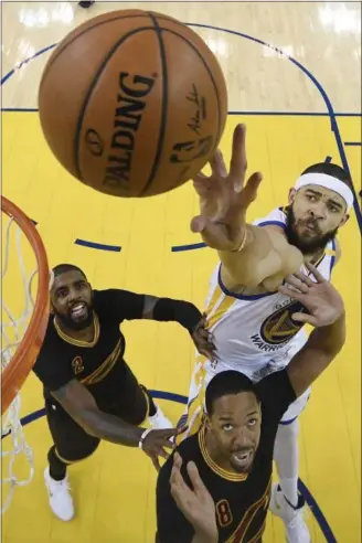  ?? KYLE TERADA — ASSOCIATED PRESS ?? Warriors center JaVale McGee, top, reaches for the ball over Cavaliers guard Kyrie Irving (2) and forward Channing Frye during the first half on June 4 in Oakland, Calif.