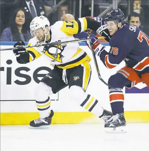  ?? Bruce Bennett / Getty Images ?? Bryan Rust is slowed down by the Rangers' Brady Skjei in the first period Friday night at Madison Square Garden.