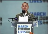  ?? AP PHOTO/ALEX BRANDON ?? Emma Gonzalez, a survivor of the mass shooting at Marjory Stoneman Douglas High School in Parkland, Fla., closes her eyes and cries as she stands silently at the podium for the amount of time it took the Parkland shooter to go on his killing spree during the March 2018 “March for Our Lives” rally in support of gun control in Washington.