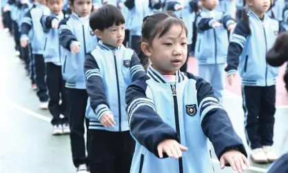  ?? Photograph: Xinhua/Rex/Shuttersto­ck ?? Students exercise at an elementary school in Nanning, capital of Guangxi Zhuang autonomous region.