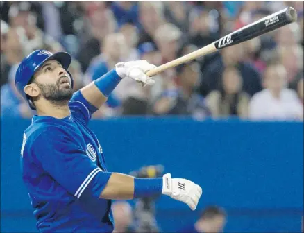  ?? Fred Thornhill, Reuters ?? Toronto Blue Jays outfielder Jose Bautista looks at a pop foul in the sixth inning of their game against the Baltimore Orioles in Toronto on Saturday. In nine games this season, Bautista is hitting just .206, with one home run and two runs batted in.