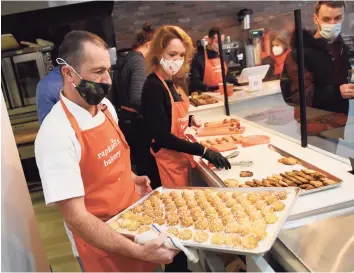  ?? Tyler Sizemore / Hearst Connecticu­t Media ?? Owner Raphaël Dequeker brings out a fresh tray of desserts beside his wife and business co-owner Charlotte Dequeker at the opening of Raphaël's Bakery in Greenwich. Located at 146 Mason St., the French Bakery features fine bread, patisserie and espresso from the former head pastry chef at Valbella in Riverside.